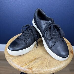 Kenneth Cole black leather sneakers with gold accents on heel, size 7
